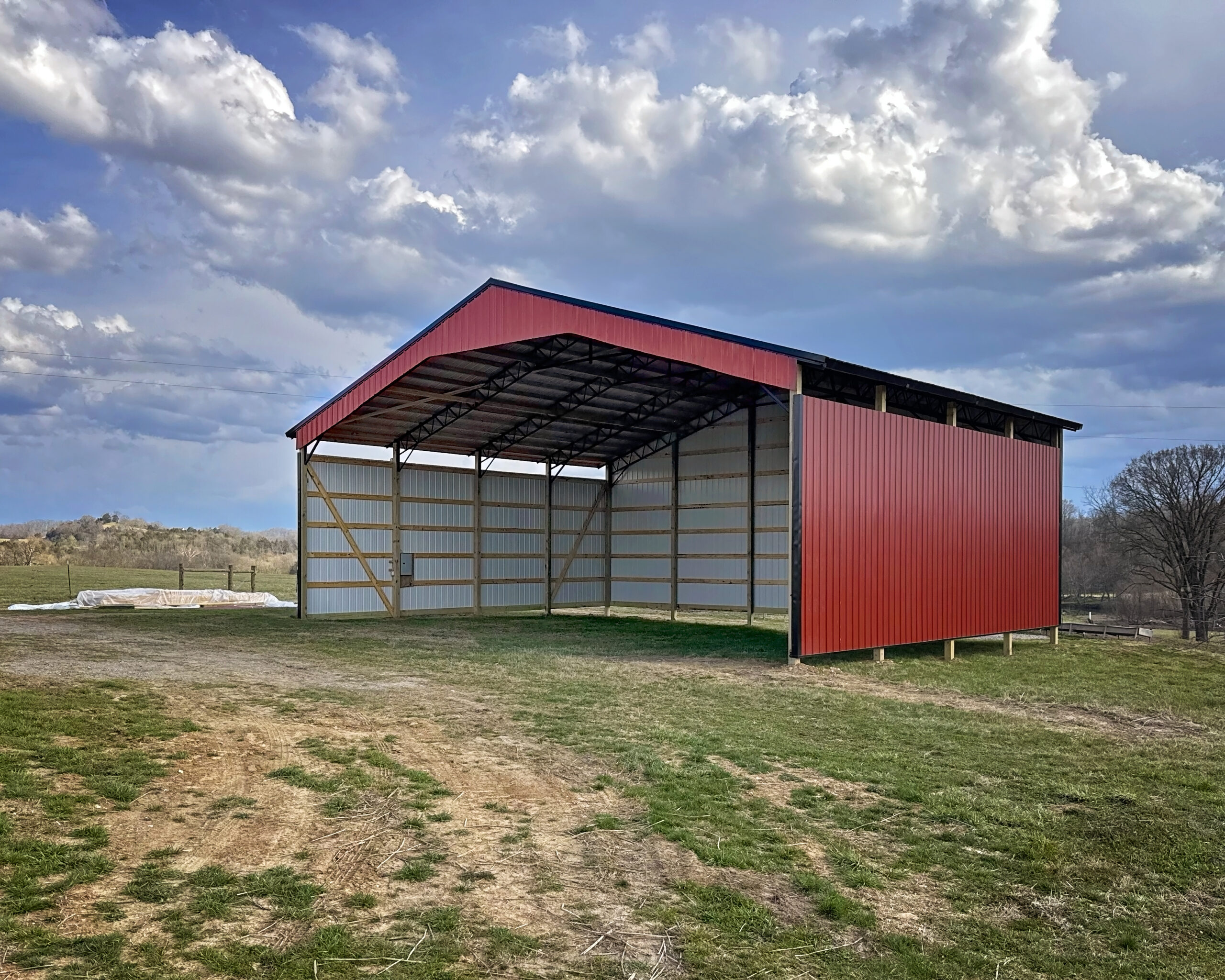Red agricultural equipment pole barn