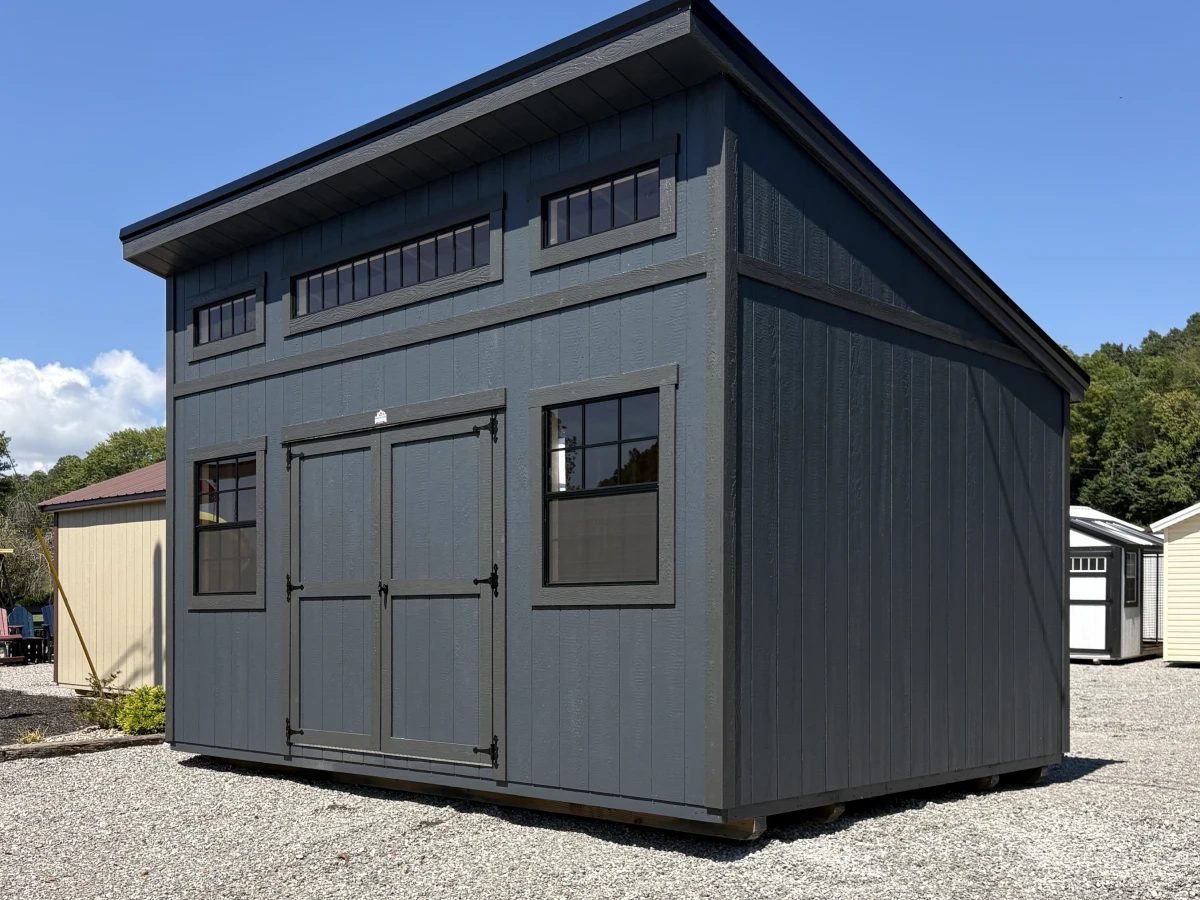 Charcoal-gray modern shed with a slant roof, clerestory windows, and black trim