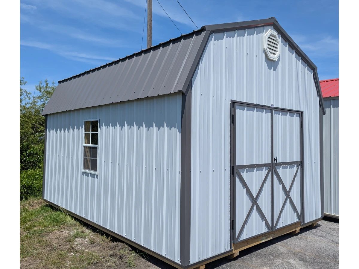 Small gray gambrel-roof shed with dark trim and double doors