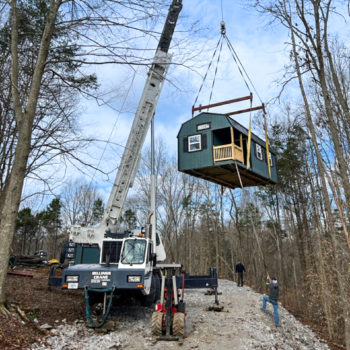 crane installing shed for shed delivery